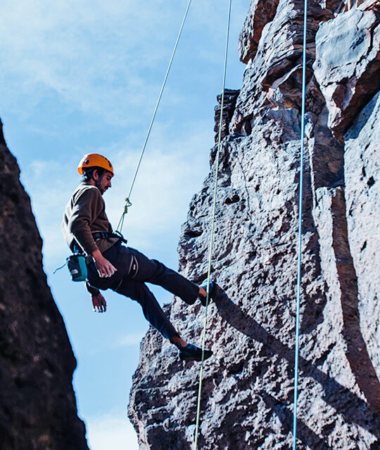 Rock Climber rappelling the Rio Grande Gorge in New Mexico
