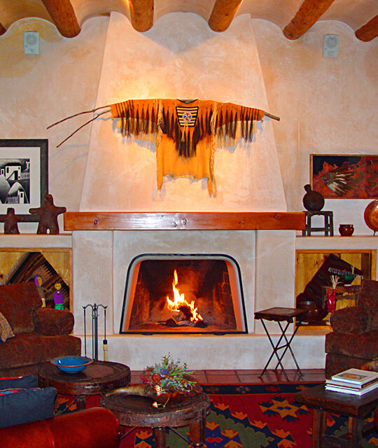 Adobe fireplace and art in adobe home