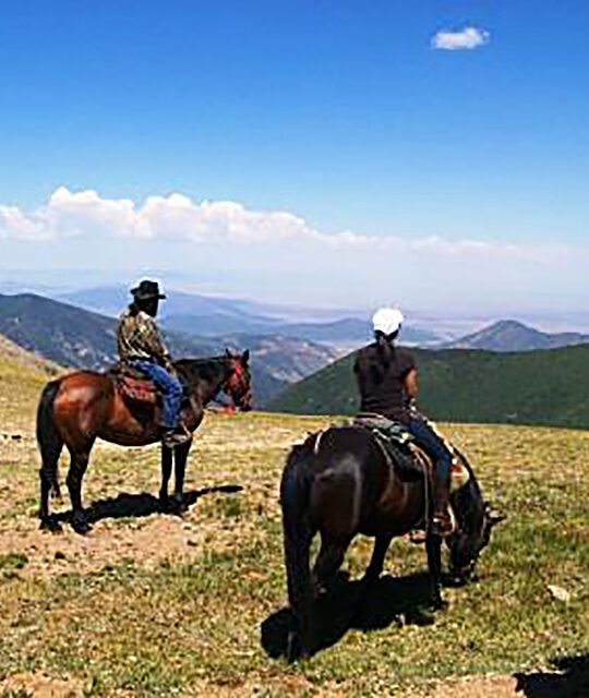 Horseback riders enjoying a mountain view in Taos Ski Valley