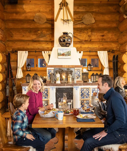 Family dining in front of The Bavarian fireplace.