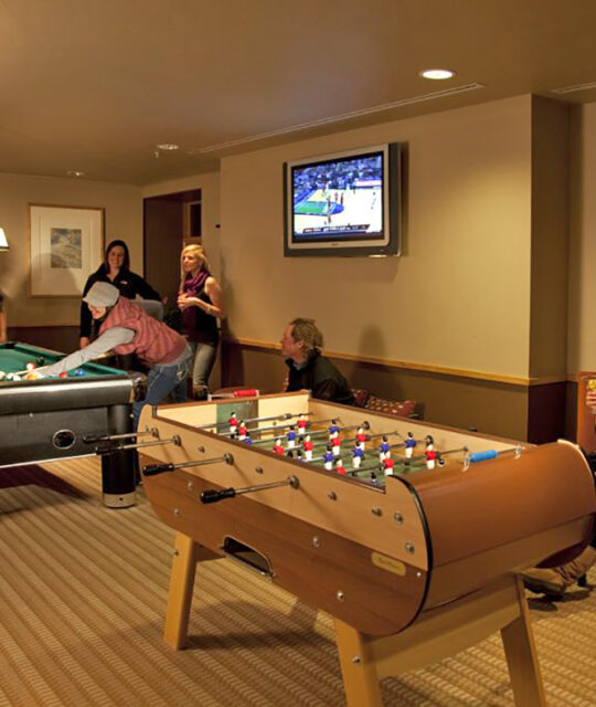 Friends gathered for a game of pool in the game room.