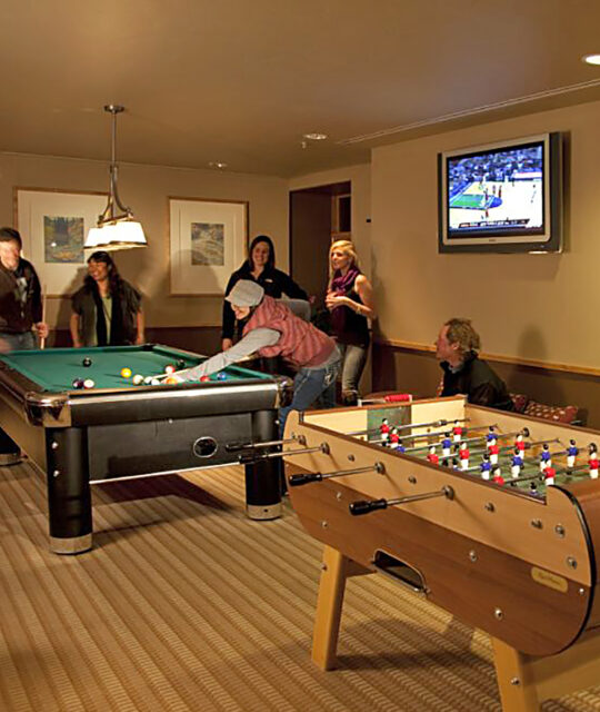 Friends gathered for a game of pool in the game room.