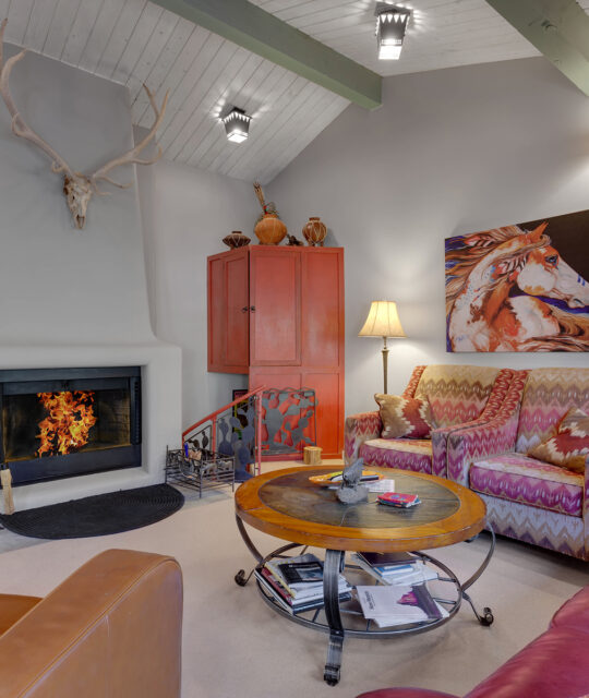 Fireplace roaring in a cozy living room.
