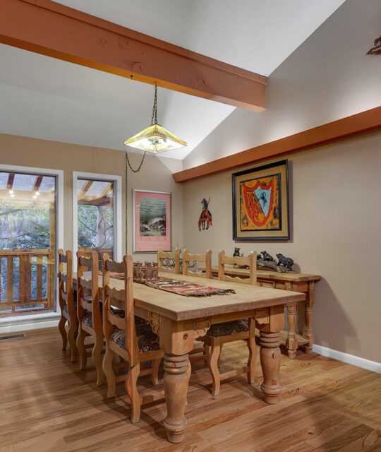 Dining room in the Kandahar Condominiums overlooking the forested mountainside at Taos Ski Valley.