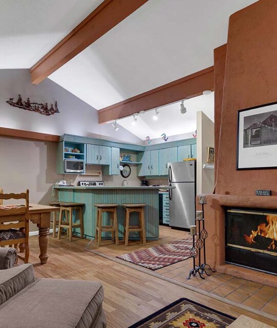 Kitchen and fireplace in a southwest decor condo.