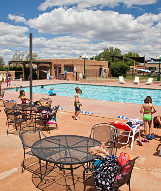 Outdoor swimming pool and kids at Quail Ridge Taos