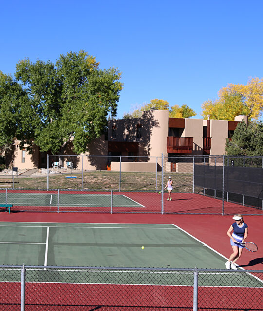 Tennis courts and players at Quail Ridge resort in Taos
