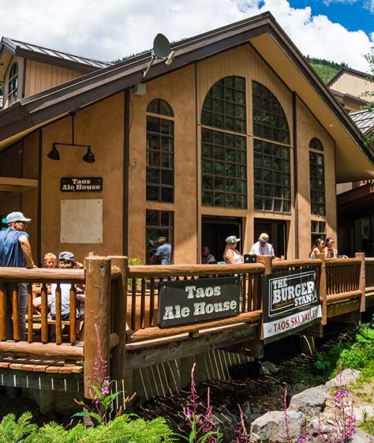 The Taos Ale House deck with diners in the summer.