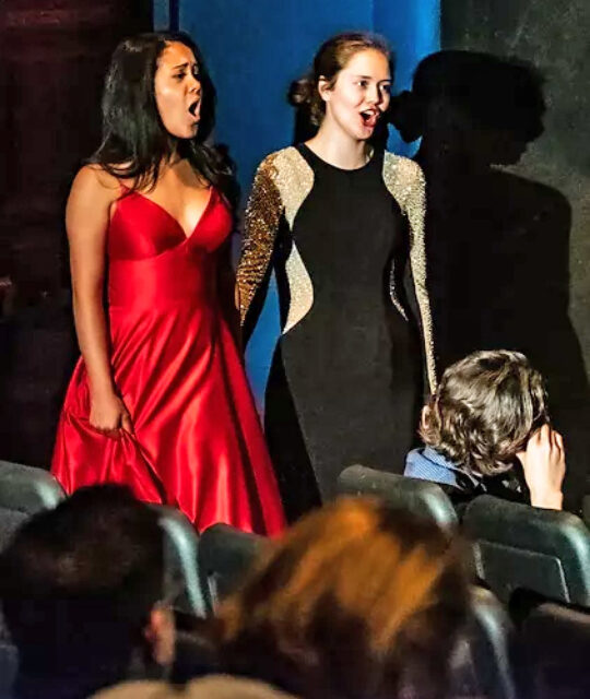 Two women opera performers in formal dress