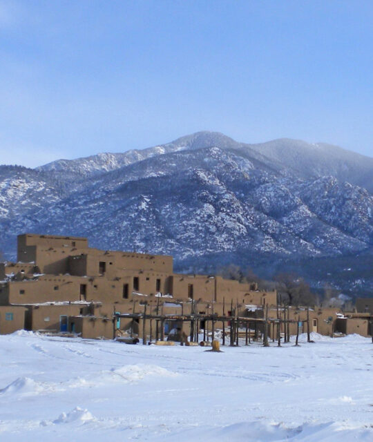 Taos Pueblo in winter with mountain background