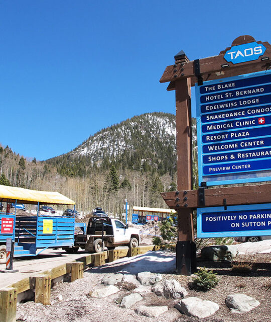 Parking lot shuttle and directional sign in Taos Ski Valley