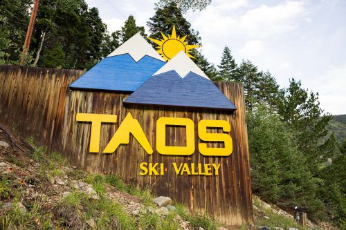 Taos Ski Valley entrance sign with wooden mountains