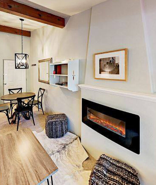 Modern southwest living and dining area with fireplace