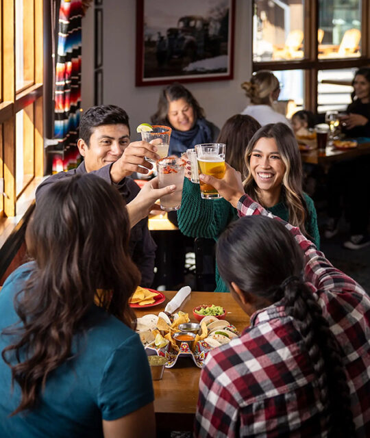 Diners toasting with margaritas at Rhoda's.