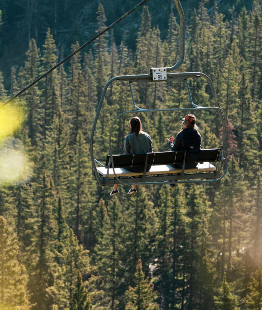Riding a scenic chairlift ride in the mountains