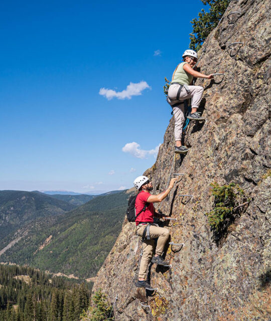 A couple enjoying a via ferrata climbing adventure