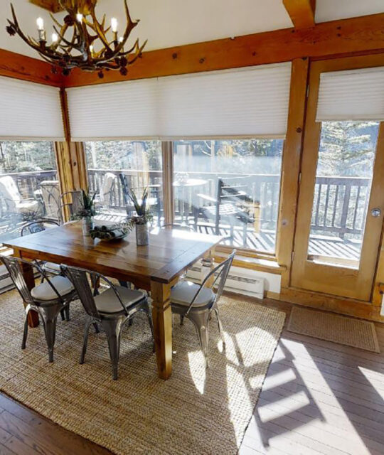 A sunny dining room with rustic furnishings