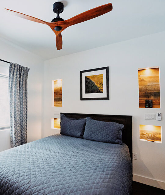 Bright modern bedroom with blue comforter in ski chalet.