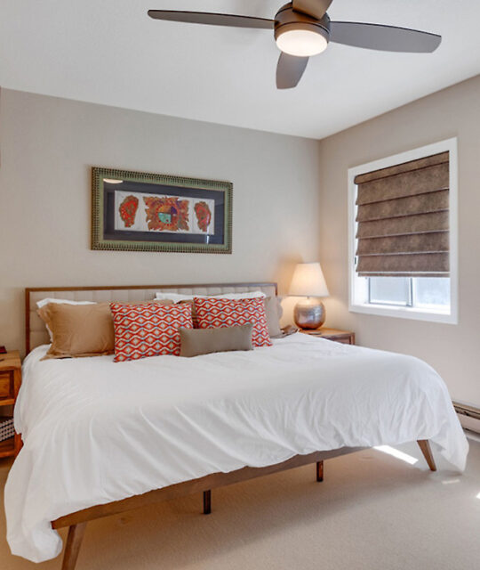 A bright bedroom with white bedding