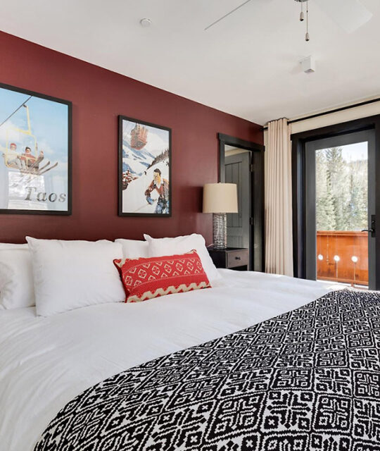 Bedroom with ski posters in vacation rental in Taos Ski Valley