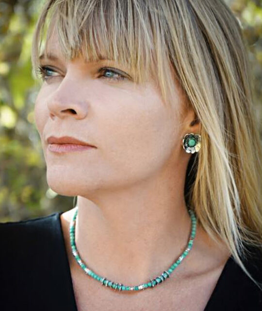 Model wearing turquoise necklace and earrings