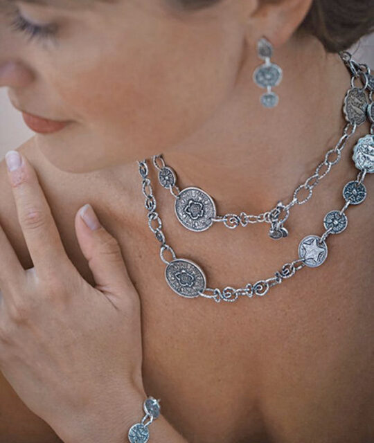 Model wearing silver chain necklace and earrings at Claireworks Gallery