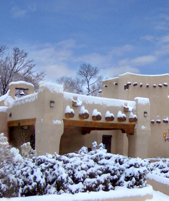 Snow on Pueblo style adobe building