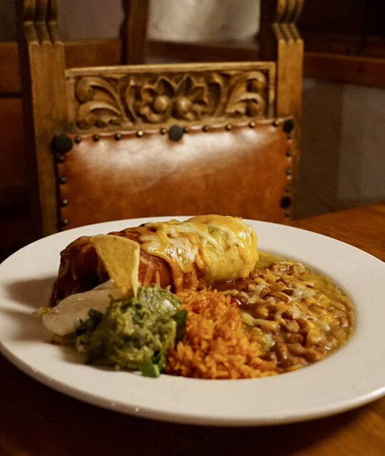 Smothered burrito with rice and beans.