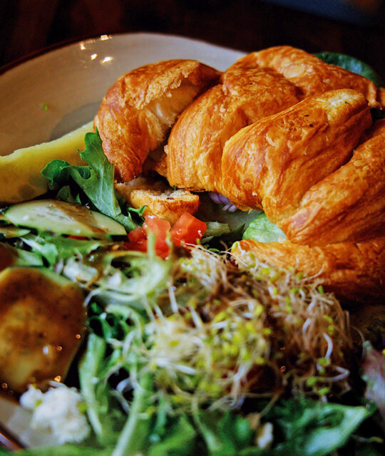 Croissant sandwich and salad