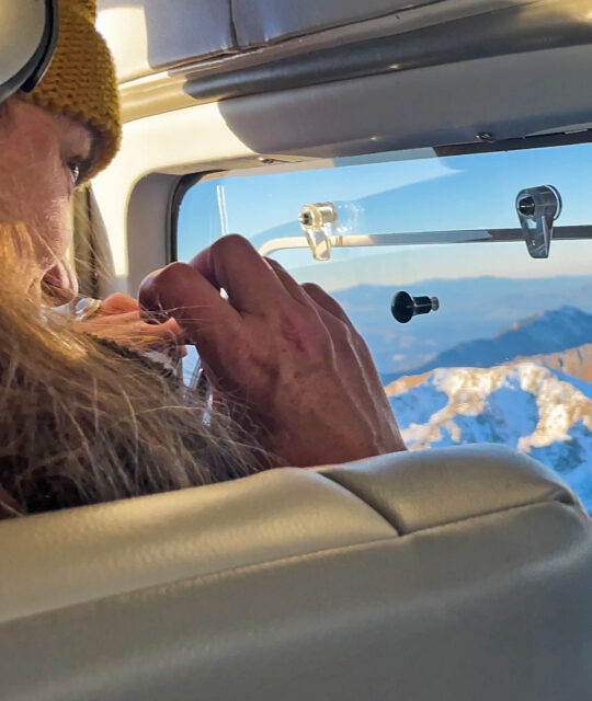 Small airplane passenger taking a photo