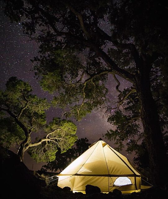 Heritage Inspirations Guided Tours Glamping tent at night with the Milky Way and stars in the sky.