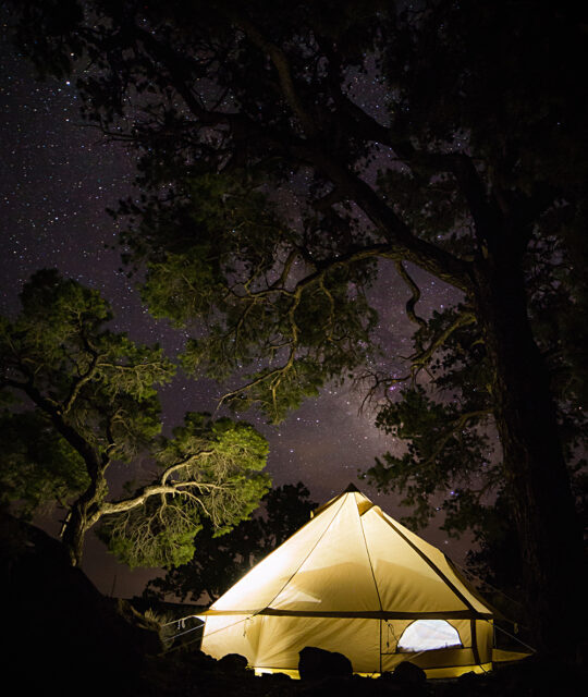 Heritage Inspirations Guide Tours Glamping tent at night with the Milky Way and stars in the sky.