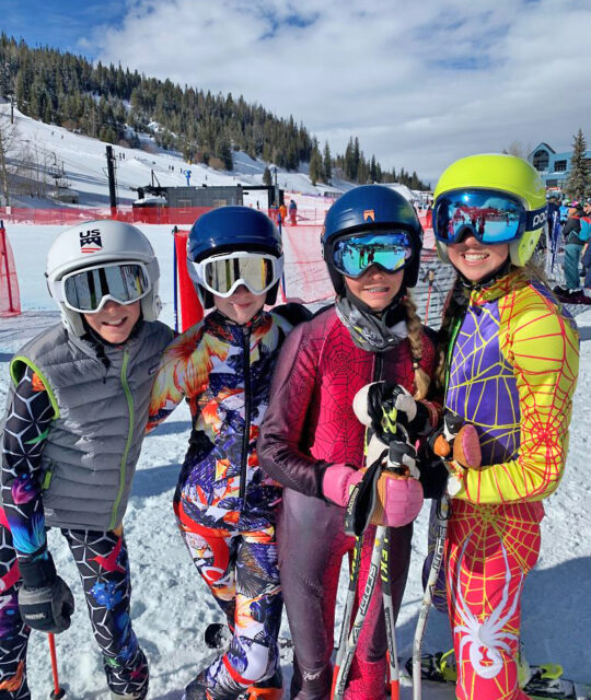 Young girls in ski racing gear.