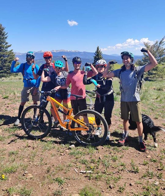 Group of mountain bikers having fun at a mountain overlook.