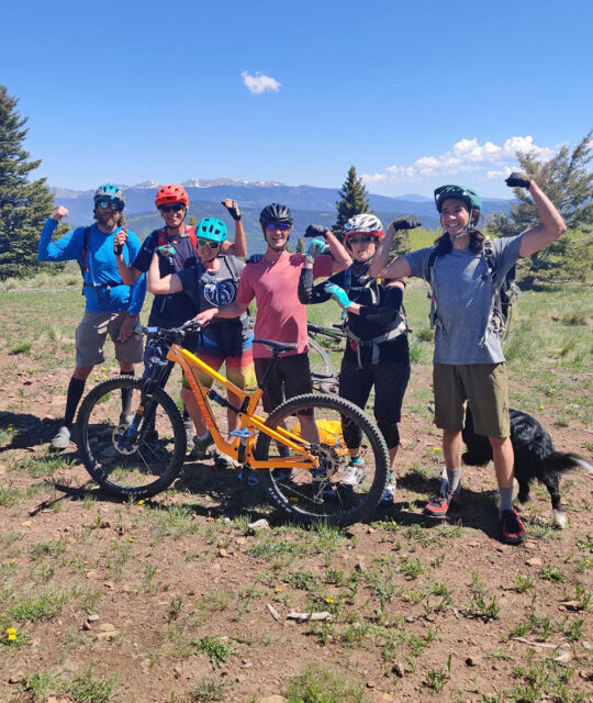 Group of mountain bikers having fun at a mountain overlook.
