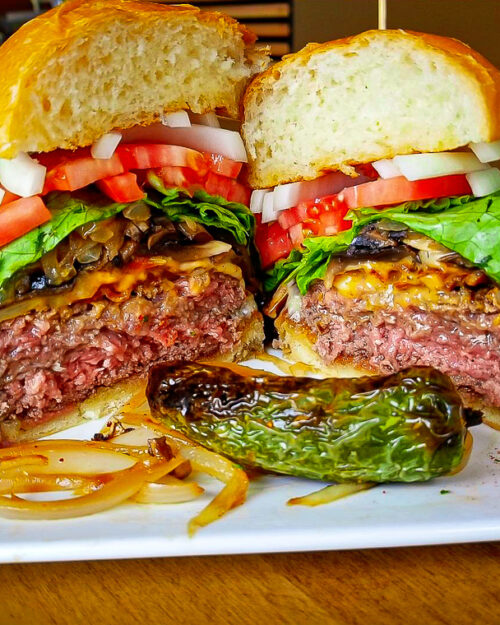 A huge green chile cheese burger with fries and jalapeño from the Burger Stand at Taos Ale House.