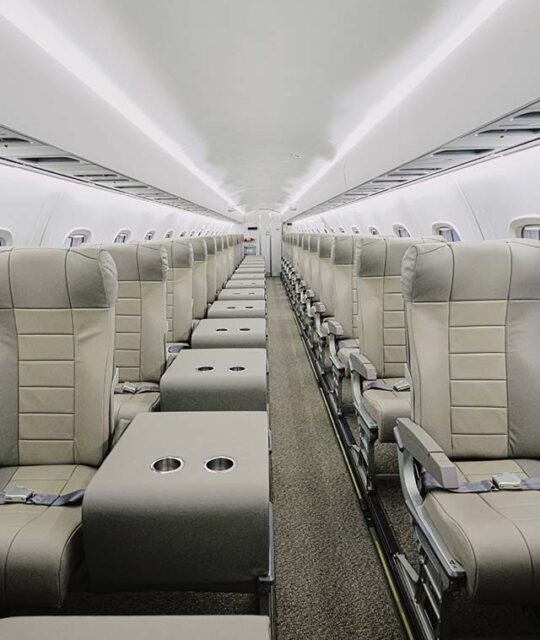 Airline interior single seats on each side of aisle.