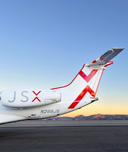 JSX airplane tail at sunset.
