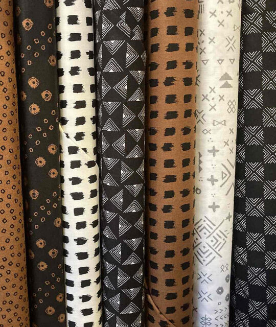 Selection of brown and black patterned fabrics.