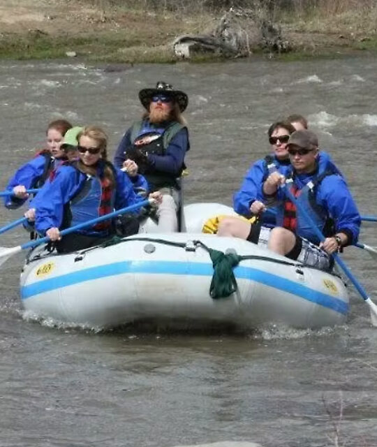 Rafting guide with customers on a mellow section of the river.