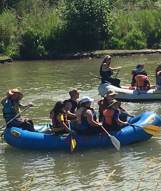 Two rafts with customers on a river float trip.