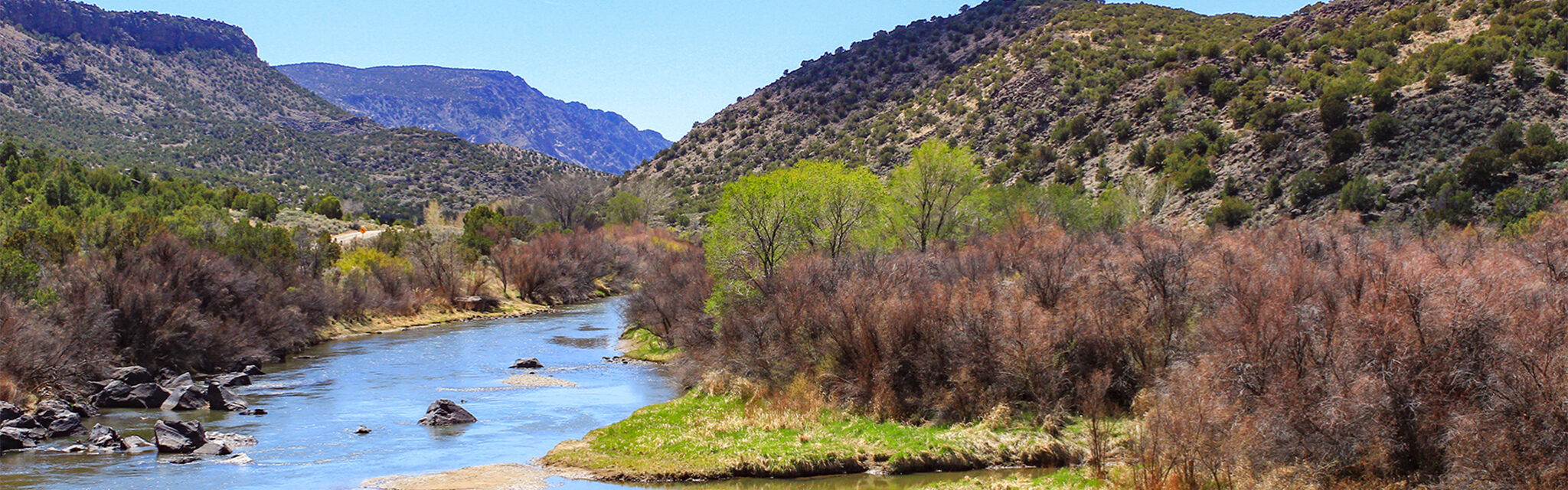 The Rio Grande flows through dramatic southwestern landscape in the springtime.