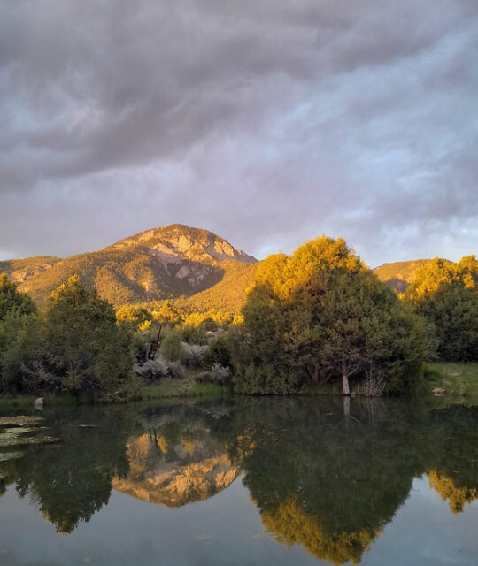 Mountain reflection on a lake at sunset.