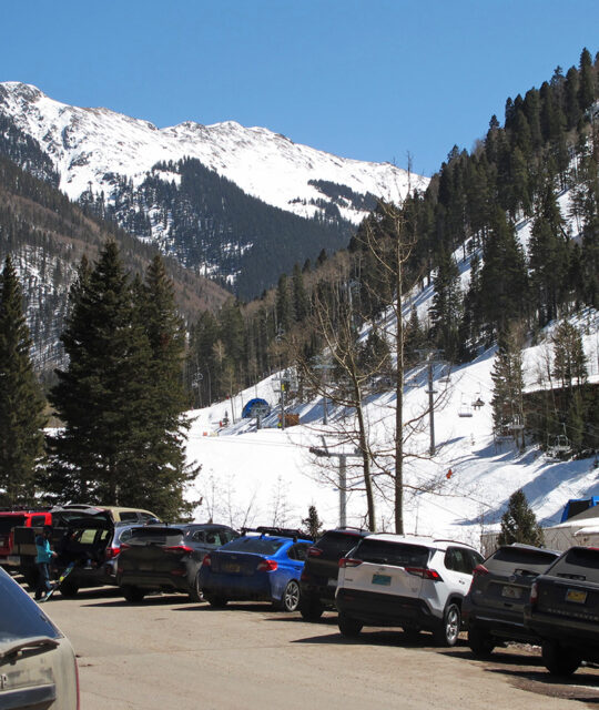 Cars parked in front of the slopes at Taos