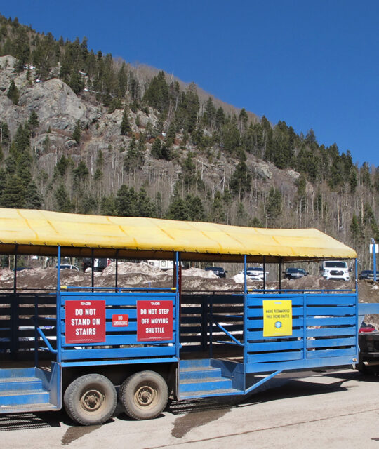 The blue parking lot shuttle trailer at Taos Ski Valley