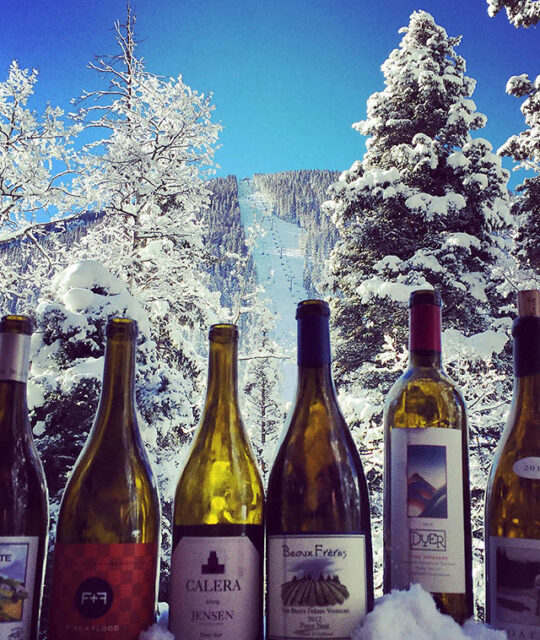 Wine bottles with Taos Al's Run in the background.