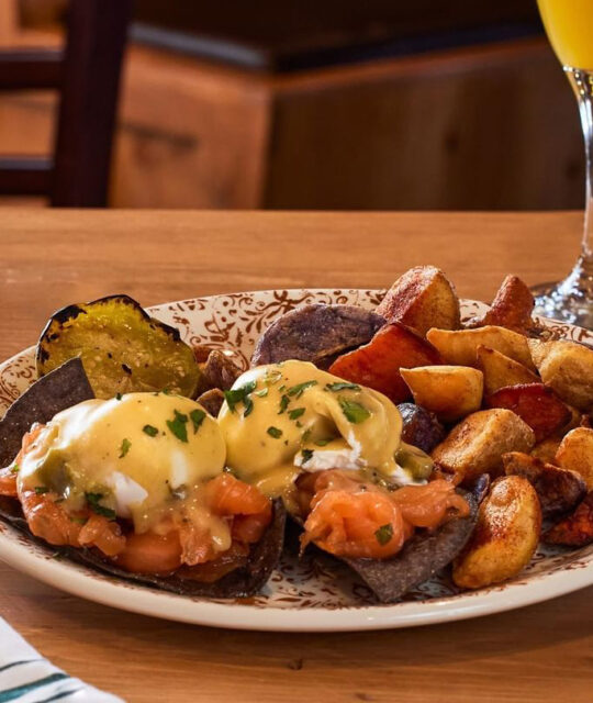 Eggs benedict blue corn tostadas and breakfast potatoes.