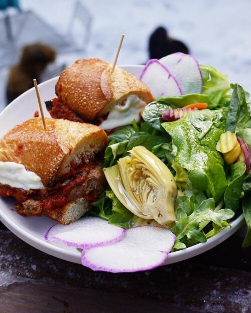 Meatball sandwich and fresh salad