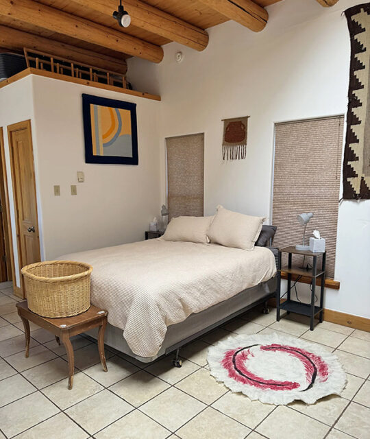 Southwest Taos Wools Casita bedroom with viga ceiling.