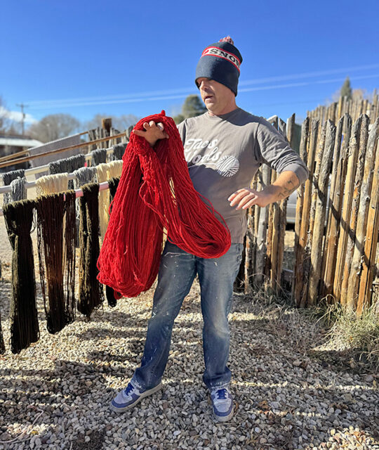 Man holding hand-dyed yarns